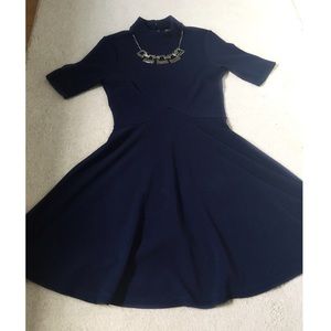 Navy blue dress with attached silver necklace.
